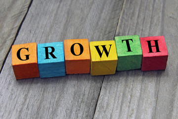 Wall Mural - concept of growth word on wooden colorful cubes