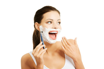 Portrait of happy woman shaving beard