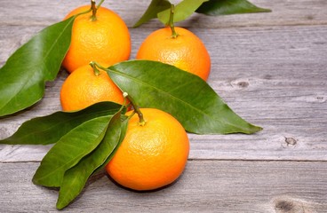 Mandarin or tangerine fruit isolated on wooden background