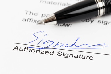 Signature on document with pen