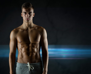 Wall Mural - young male bodybuilder with bare muscular torso