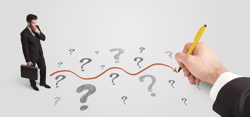 Business man looking at question marks and solution path