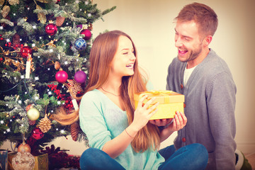 Wall Mural - Happy Couple with Christmas Gift at Home. Christmas Celebration