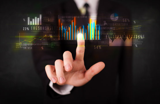 Young business person touching colorful charts and diagrams
