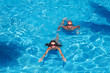 © Petrik - Couple swimming in pool