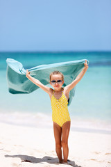 Wall Mural - Cute little girl having fun on beach vacation