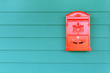© Kittiphan - Red mailbox with green wood background