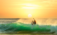 Surfer Surfing At Sunrise