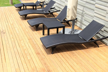 Wall Mural - sun loungers stand on decking at pool