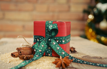 small gift with cinnamon for christmas on old wooden table and r