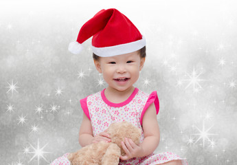 Wall Mural - Happy asian girl with christmas hat over snow background