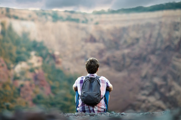 Man sitting on rocky cliff