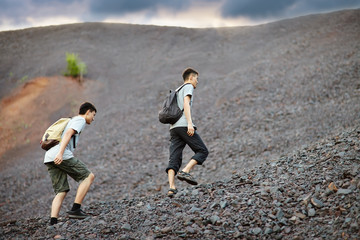 Wall Mural - Men walks on stones slope