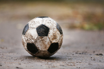 Poster - Soccer ball on ground in rainy day, outdoors