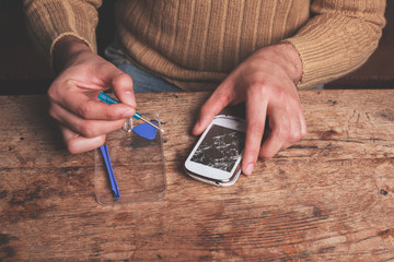 Wall Mural - Technician fixing smart phone