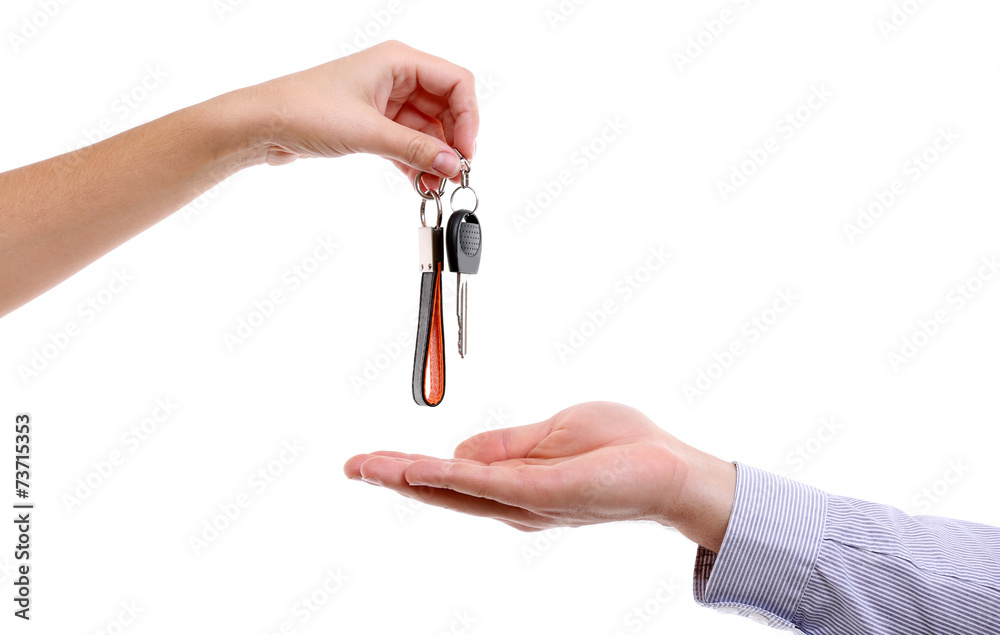 Businessman holding car key isolated on white