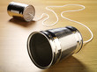 Two tin cans on a wooden background, communication concept