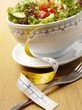 Salad bowl with a tape measure for a healthy lifstyle