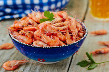 Wall Mural - Prepared shrimp on blue plate on wooden background