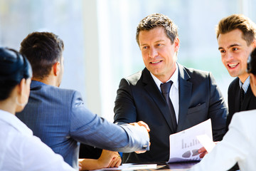 Wall Mural - Business colleagues sitting at a table during a meeting