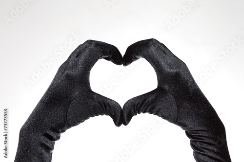 Obraz w ramie Black heart shaped gloves isolated on white background