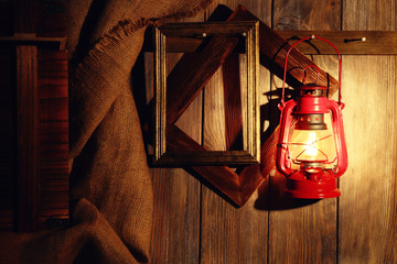 Lantern hanging on hook on wooden wall