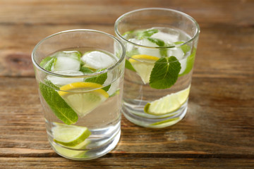 Poster - Summer cocktail with ice cubes on wooden table