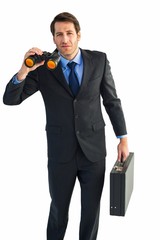 Poster - Serious businessman holding binoculars and a briefcase