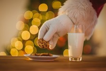 Hand Of Santa Claus Picking Cookie