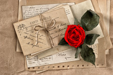 Red Rose Flower And Old Letters. Vintage Postcards And Papers