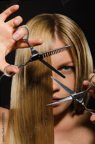 Fototapeta dla dzieci Young woman with straight hair and scissors