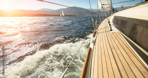Nowoczesny obraz na płótnie Yacht sailing towards the sunset. Sailing. Luxury yachts.