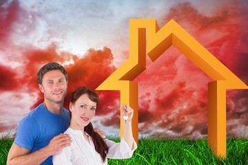 Poster - Composite image of couple holding keys to home