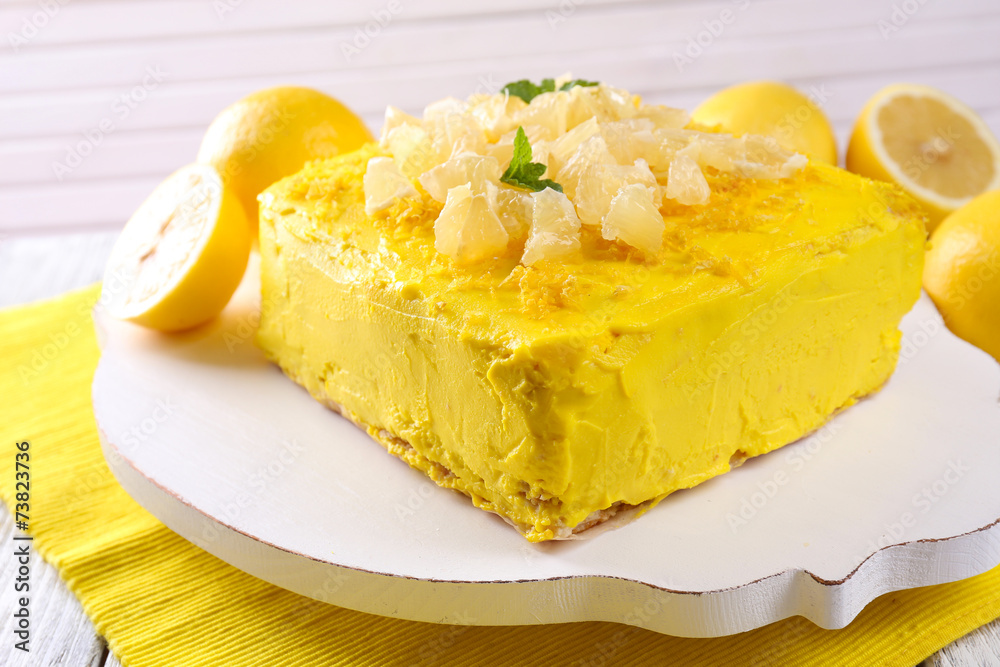 Tasty lemon cake on wooden table