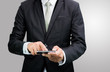 © sorapop - Businessman standing posture hand hold phone isolated