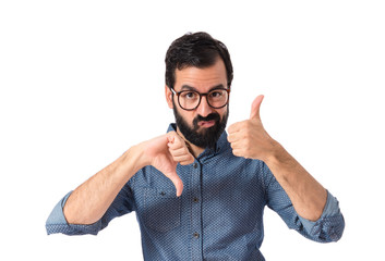 Wall Mural - Young hipster man making a good-bad sign