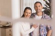 © WavebreakMediaMicro - Smiling couple cuddling near the christmas tree