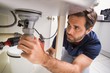 © WavebreakMediaMicro - Plumber fixing under the sink