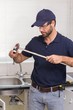 © WavebreakMediaMicro - Plumber fixing pipe with wrench