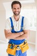 © WavebreakMediaMicro - Handyman smiling at camera in tool belt