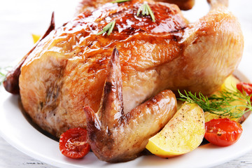 Wall Mural - Delicious baked chicken on plate on table close-up