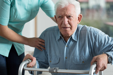 Canvas Print - Handicapped man using walker