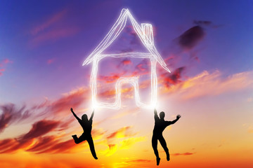 A couple jump and make a house symbol of light. New home