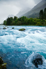 Milky blue glacial water of Briksdal River in Norway