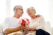© Syda Productions - happy senior couple with bunch of flowers at home