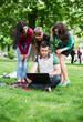 © lexmomot - Group of young college students sitting on grass