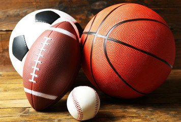 Sports balls on wooden background