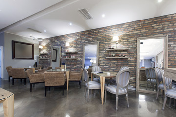 Wall Mural - Interior of a modern hotel cafe with stone wall 