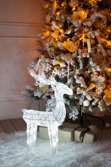 Wall Mural - A lighted Christmas tree with deer underneath.