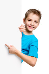 Portrait of happy little boy with white blank